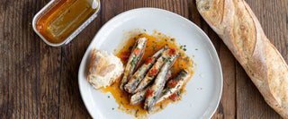 Spicy anchovies on wooden table