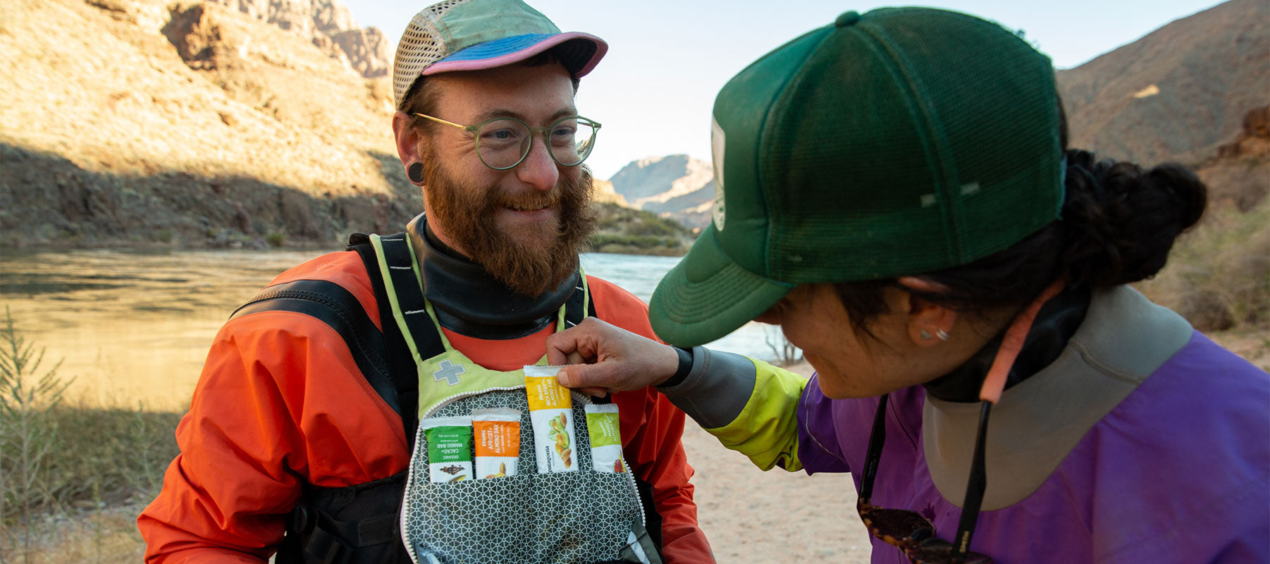 Two kayakers take a break to share Patagonia Provisions Fruit + Almond Bars