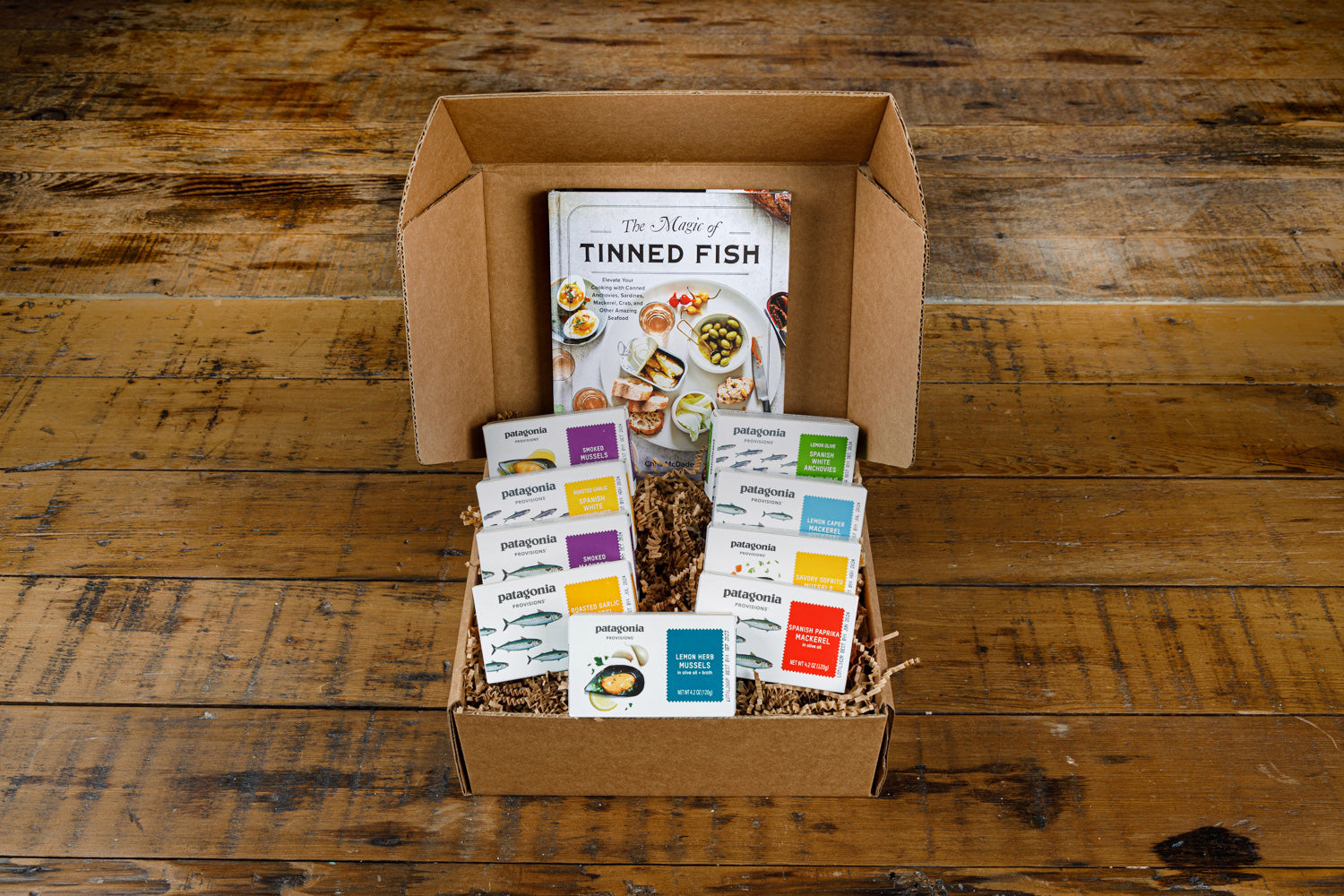 An open gift box from Patagonia Provisions on a wooden table