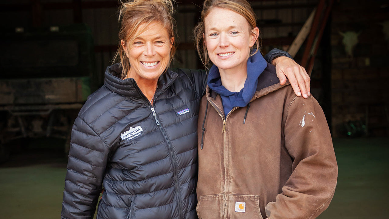A picture of two women from the O'Brien family, wearing warm jackets and standing next to a dog