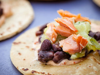 Chipotle Sour Cream, black beans, salmon layered on a small tortilla