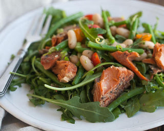 Salmon and four bean salad on a white plate