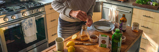 Home cook working in kitchen with fresh ingredients and Patagonia Provisions spices and honey