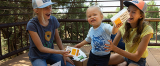 Kids opening a subscription box of tin fish