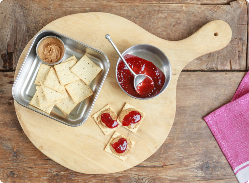 A lunch board with peanut butter and jelly