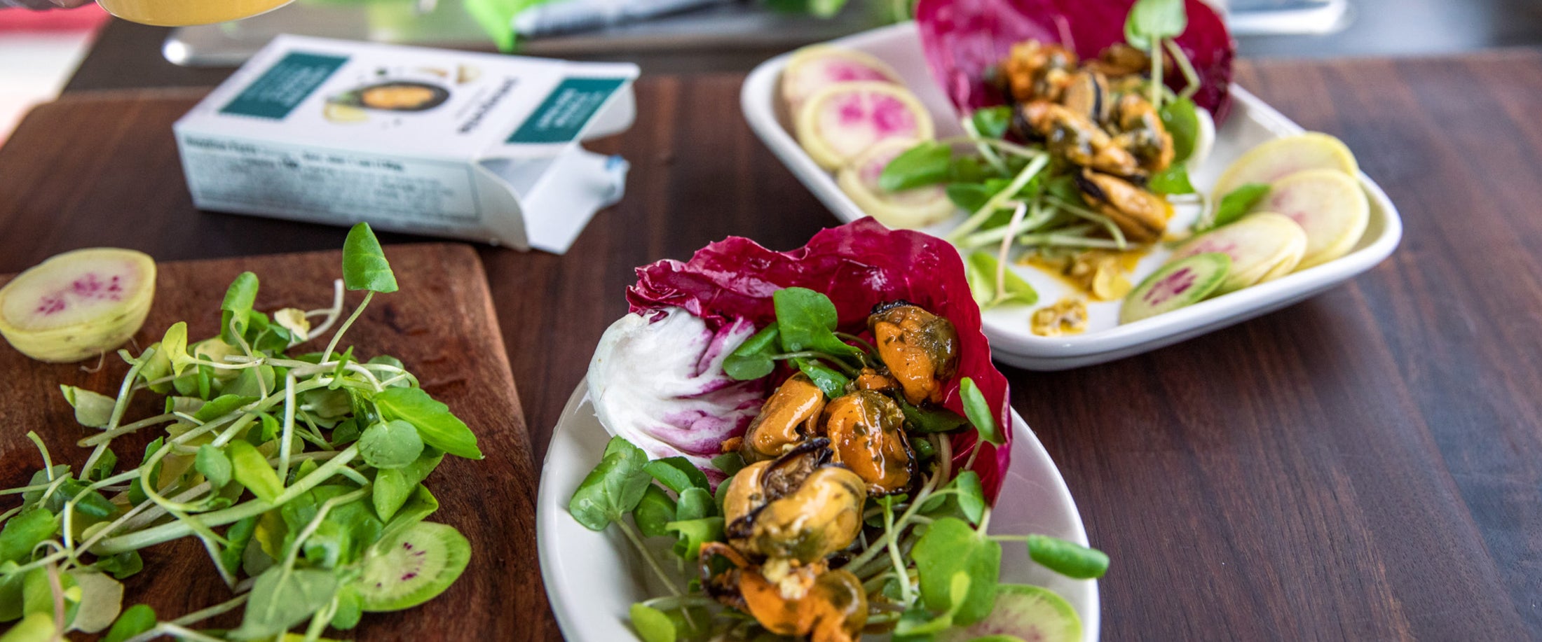 lettuce wraps with mussels on a table