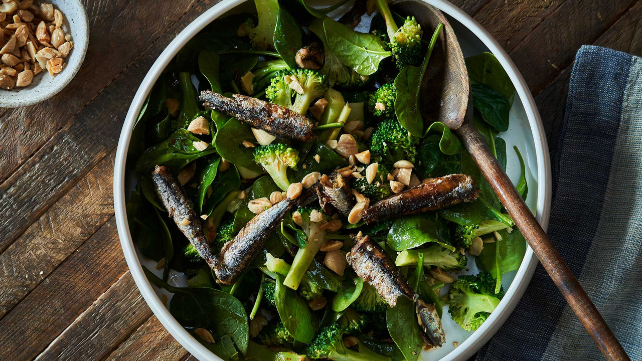 Bowl of deep green salad with broccoli, Patagonia Provisions Anchovies, and chopped peanuts