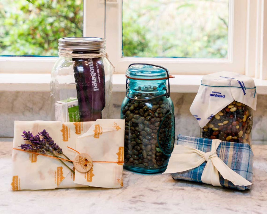 A collection of jars and wrapped packages ready for gifting on a marble countertop