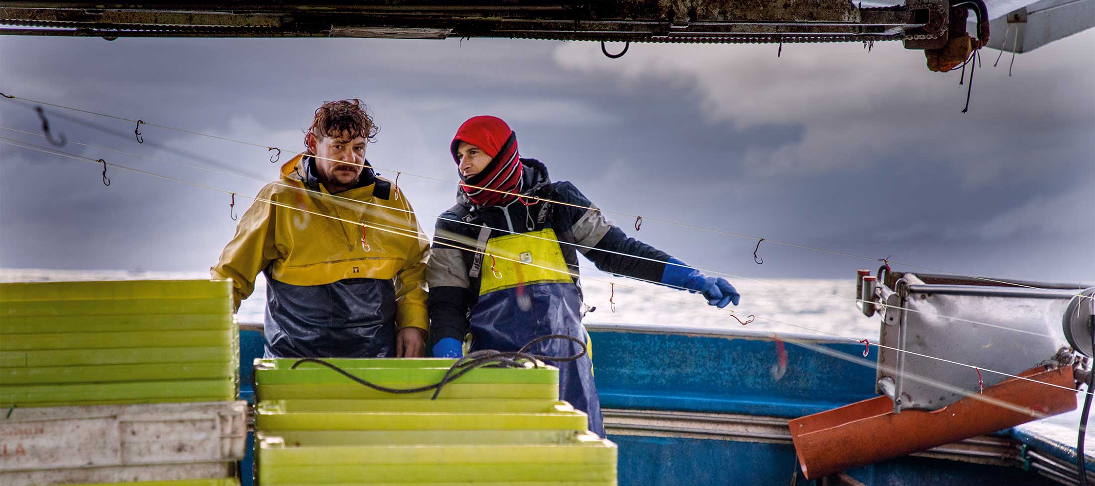 Fishermen Adrian Fernandez and Luis Miguel Fernandez on the mackerel boat Salvador Padre, heading out to the fishing grounds.