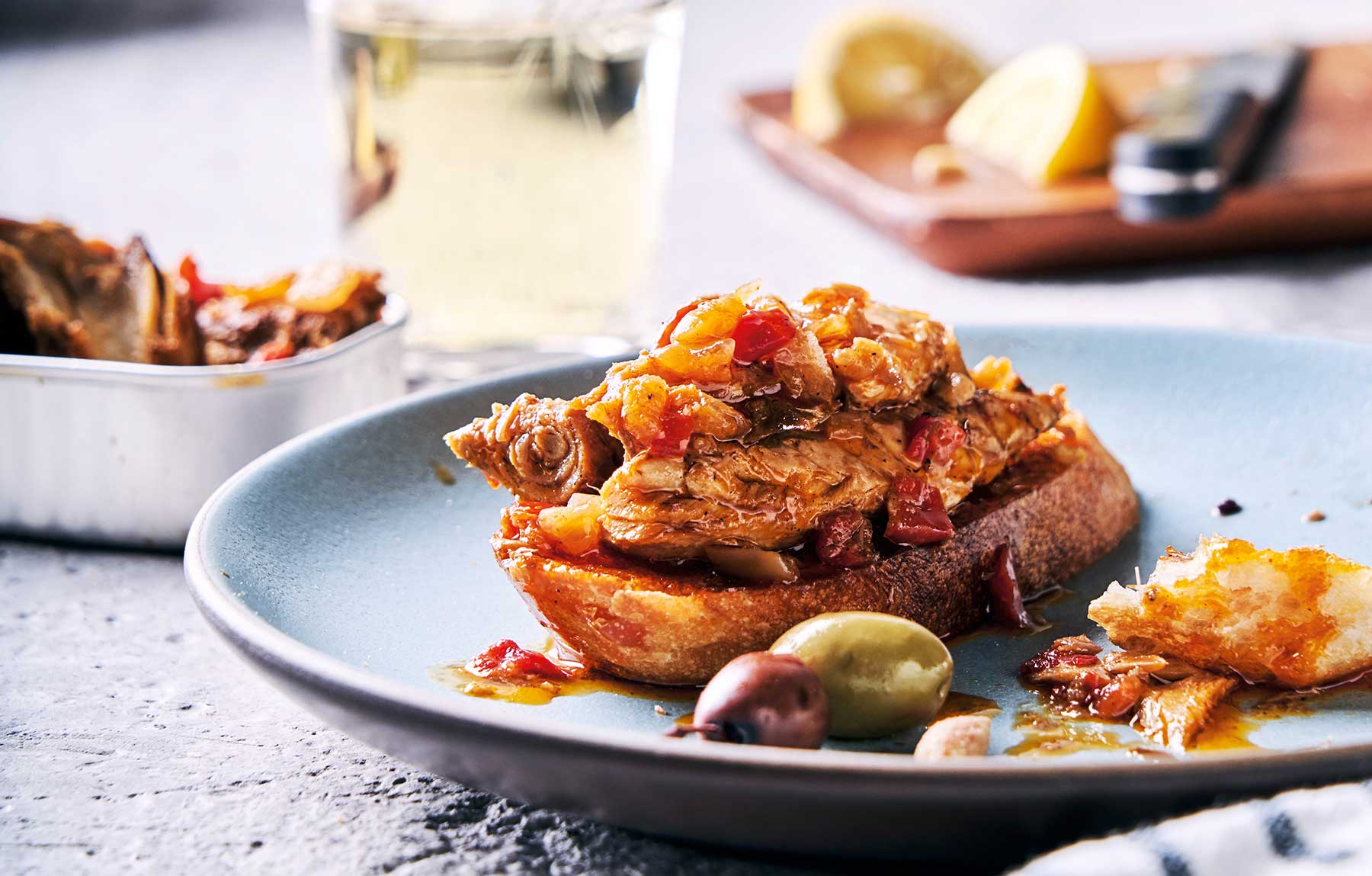 A kitchen snack of Provisions Spanish Paprika Wild Mackerel, with a glass of albariño.