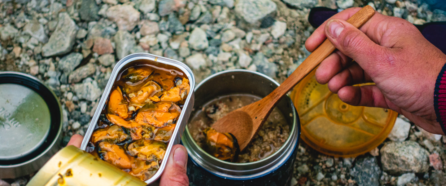 Tin of mussels open on the beach