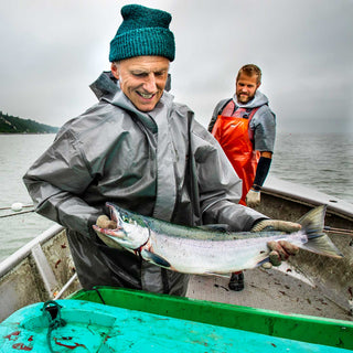 Two fishermen on a boat, one holding a wild sockeye salmon for Patagonia Provisions Wild Sockeye Salmon